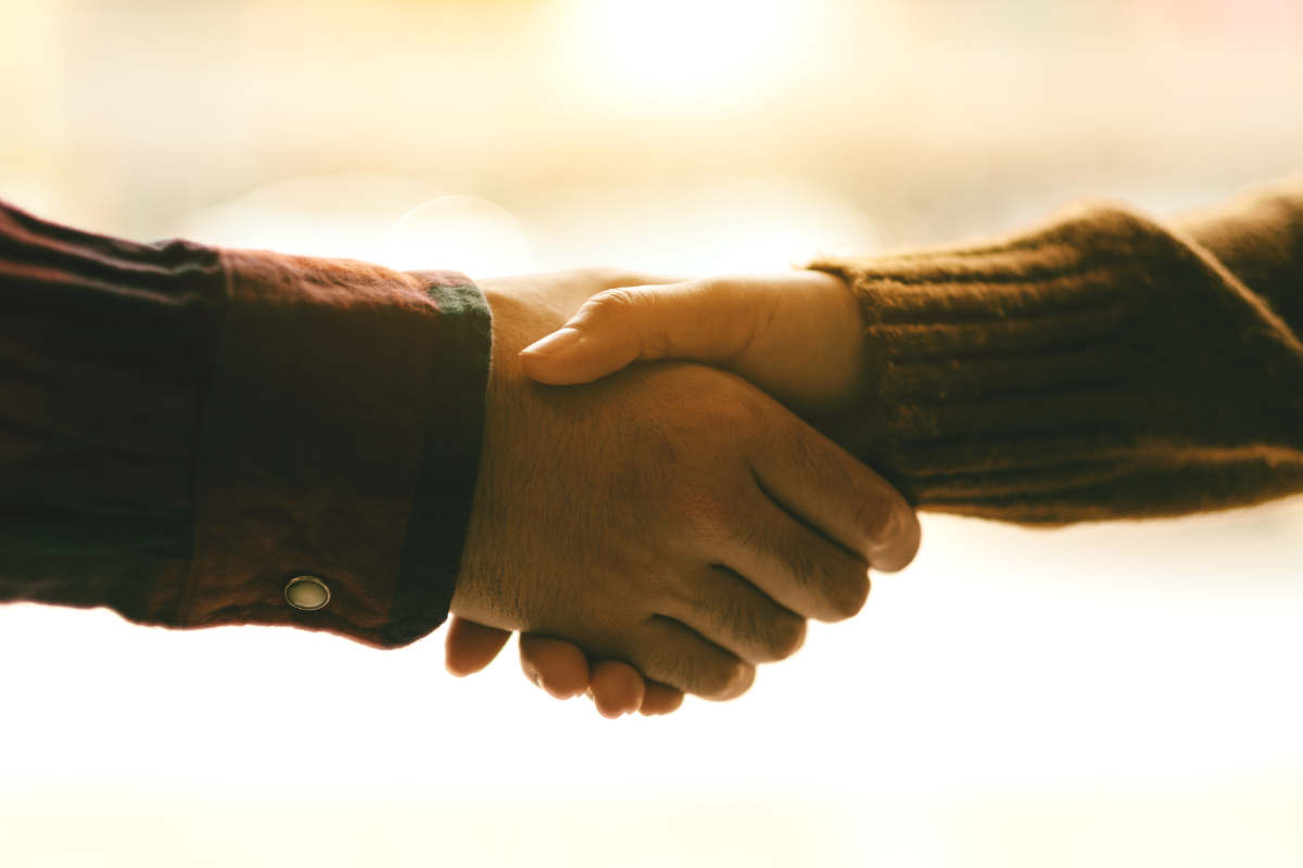 Closeup image of two people shaking hands