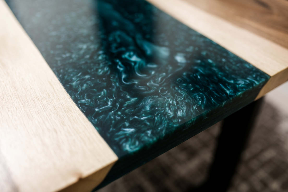 Stylish and modern new table made of wood and epoxy resin for the interior