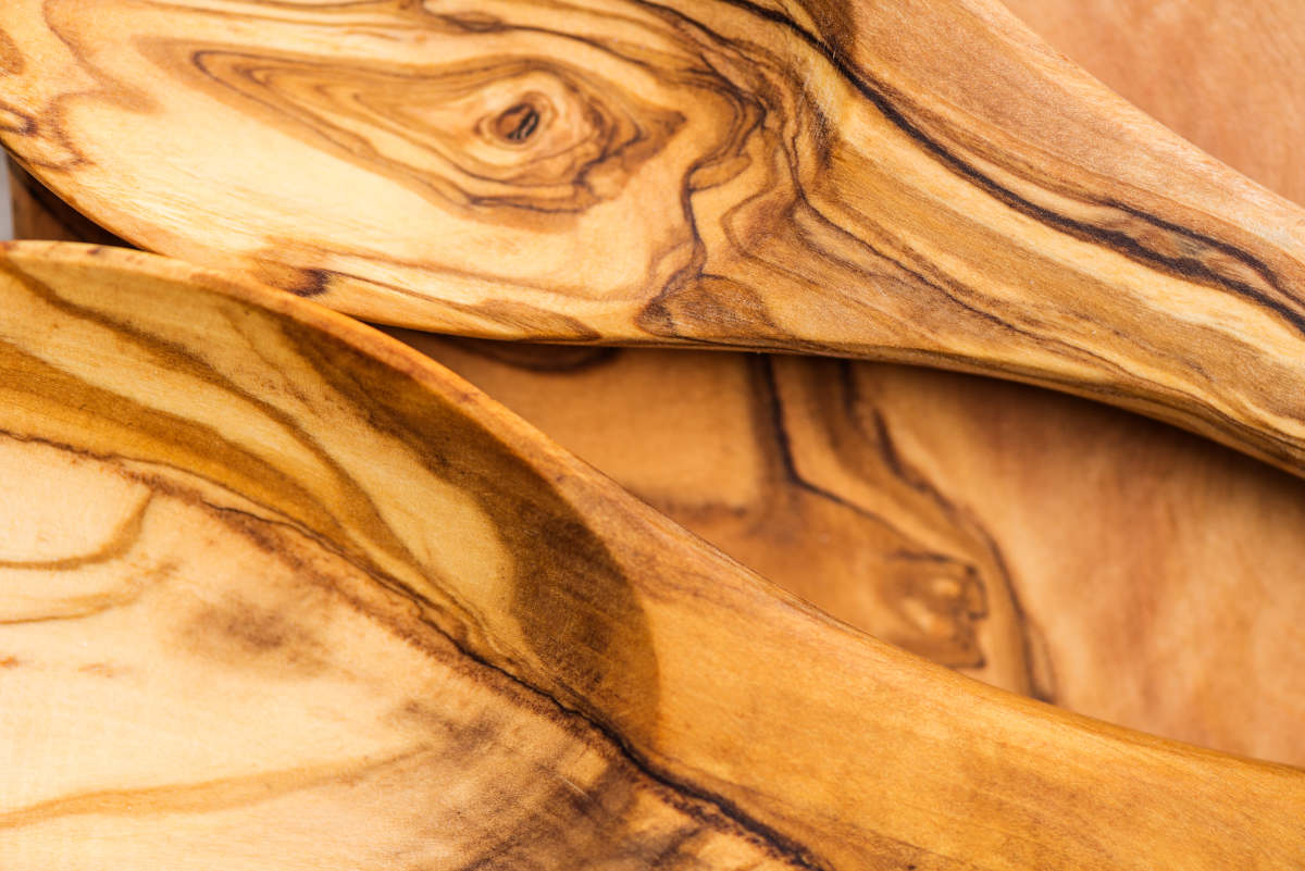 Close up of Kitchen Utensils from Olive Wood, such as Chopping Board and Salad Servers Set