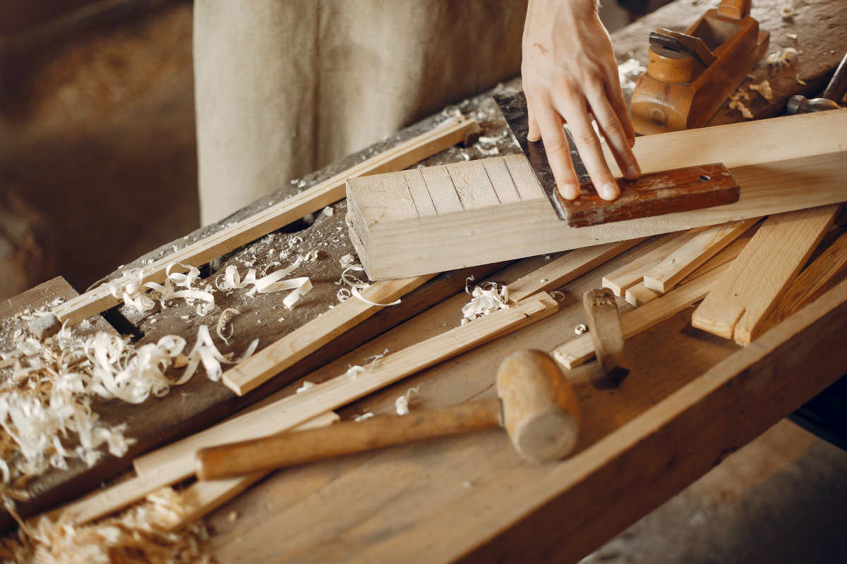 Handsome carpenter working with a wood
