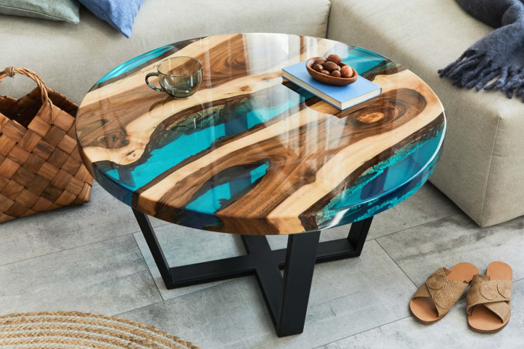 Stylish composition with design epoxy coffee table, sofa, blanke