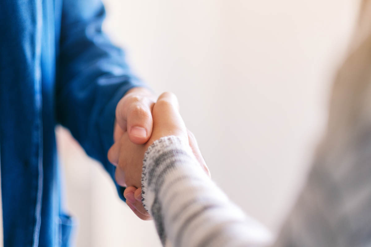 Closeup image of two people shaking hands